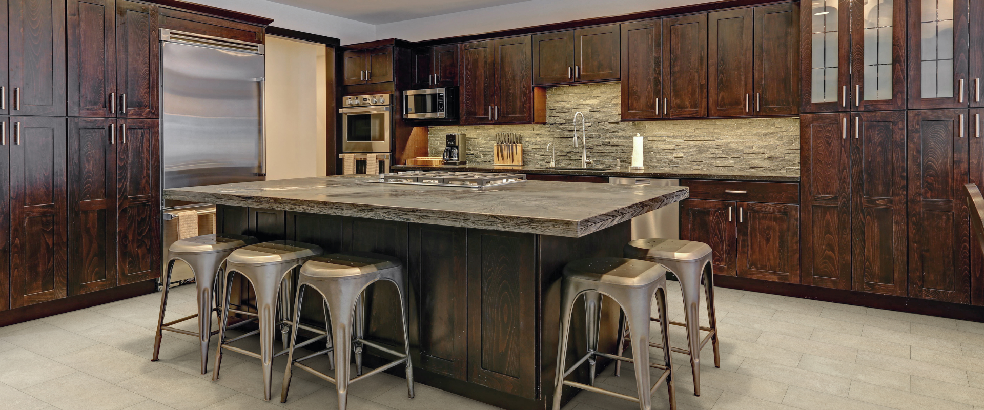 kitchen with dark cabinets island countertop with stools and tile backsplash