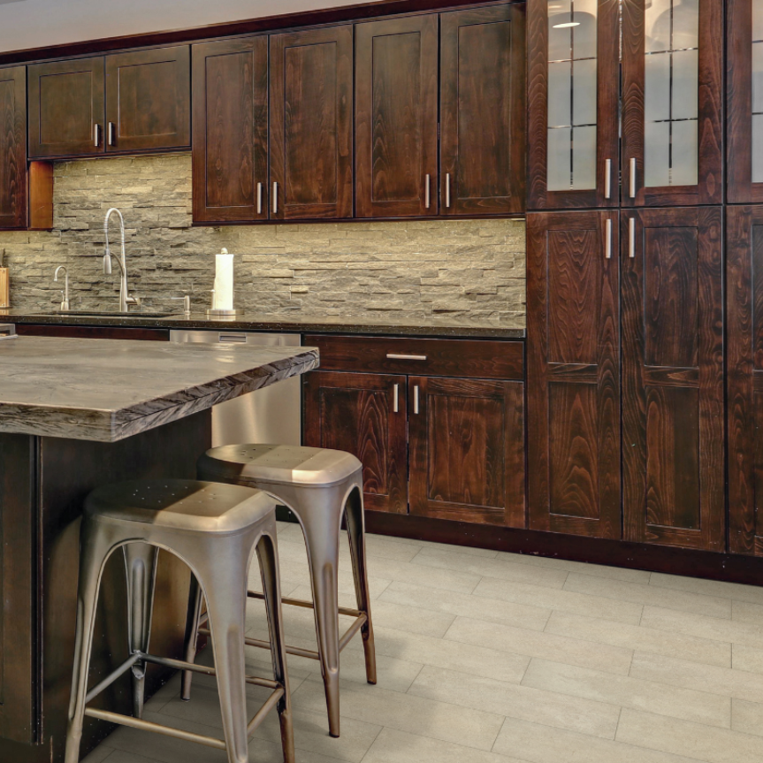 kitchen with dark cabinets island countertop with stools and tile backsplash