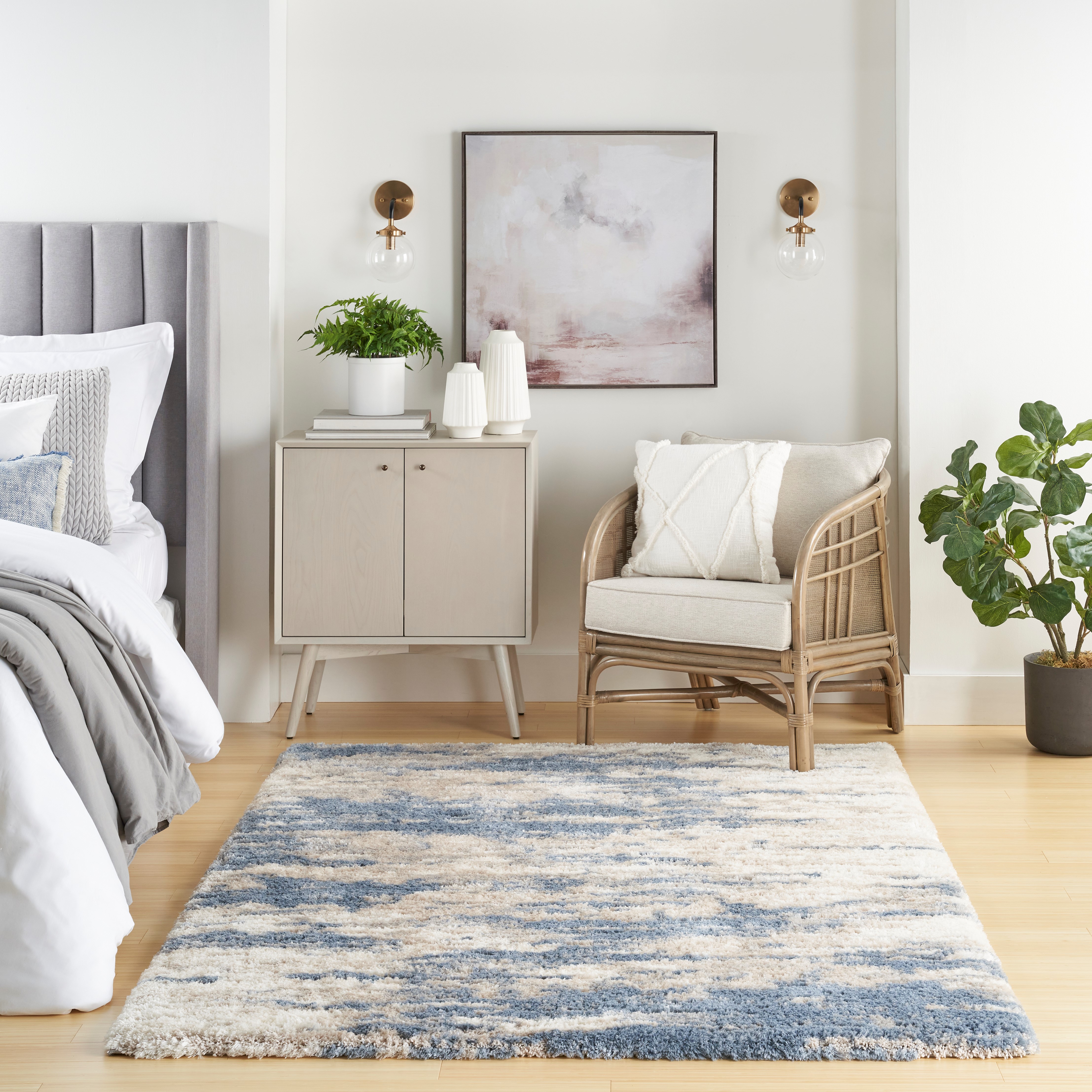 Area Rug in bedroom scene. White and light blue color scheme.